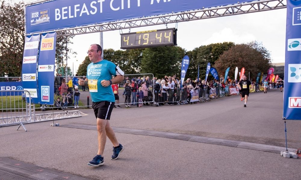 Gareth crossing the finish line at the Belfast City Marathon