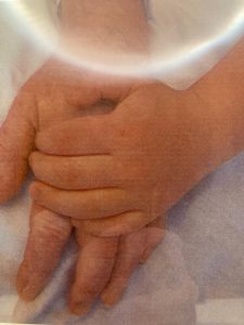 Adult and child holding hands