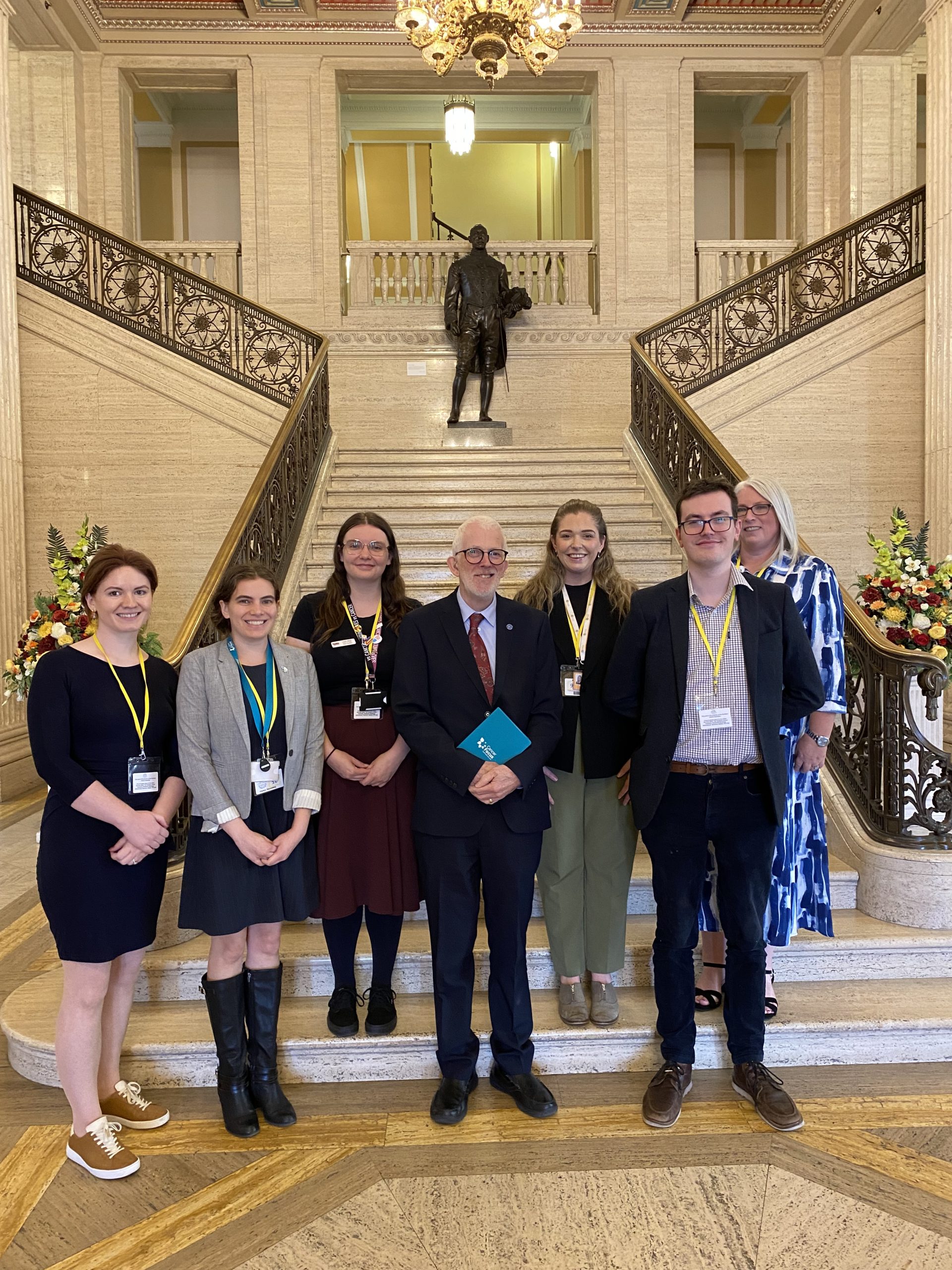 People in front of interior stairs at Stormont